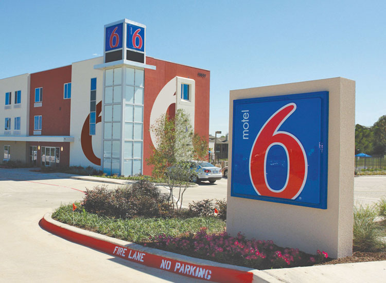 Exterior view of Motel 6 and Motel 6 monument sign